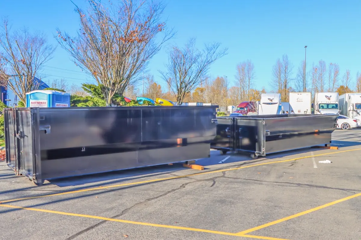 Professional dumpster rental service with roll-off container on residential driveway in Southeast